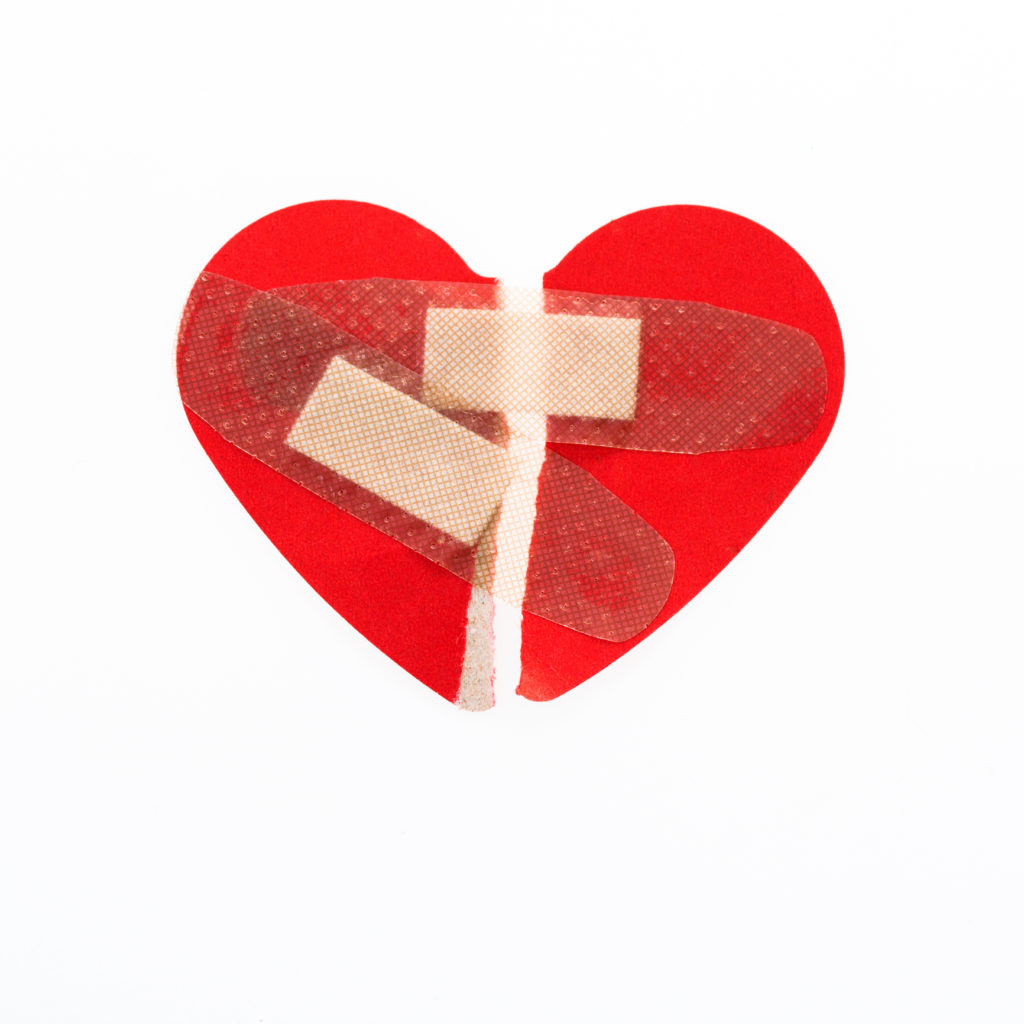 Red Broken Heart Pieced Together With Bandaids Symbolizing Healing With Group Therapy